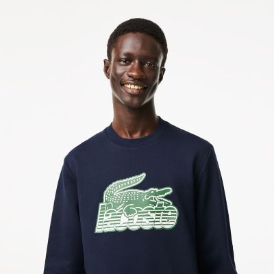 LACOSTE ニューグラフィックプリントクルーネックスウェット ラコステ