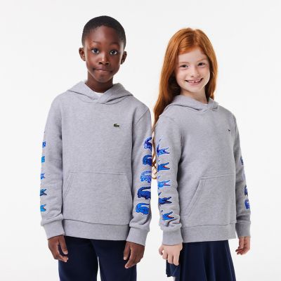 ＜LACOSTE＞タイムラインクロックスリーブプリントＪＵＮＩＯＲフーディー